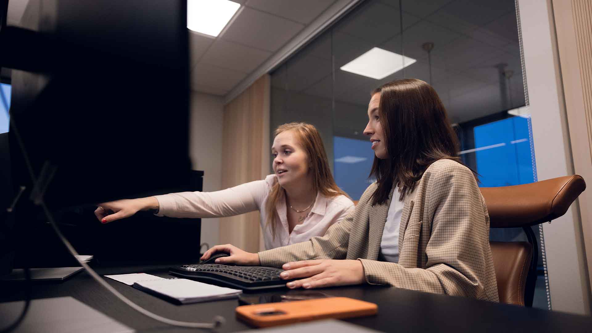 two women looking at a computer